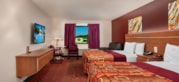 Junior Studio Suite at Grand Marquis Hotel - front view of beds, couch, table and chairs, tv, and floating dresser